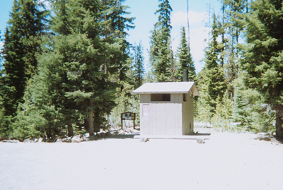 outhouse at edge of woods