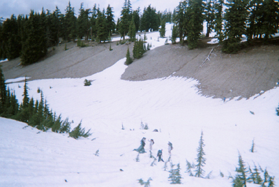 Hikers at bottom of snowy valley