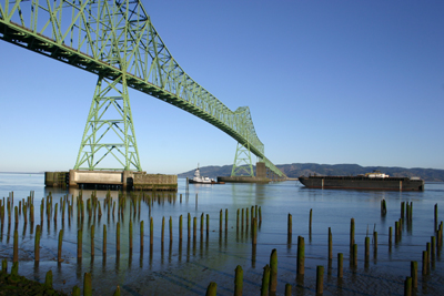 Tug & barge going down the Columbia under bridge