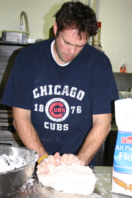 Pastor Mark kneading bread dough