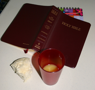 Bible, notebook, bread, and juice for communion