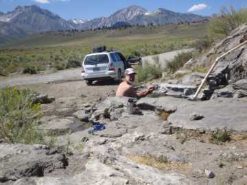 Mike soaks in a mossy hot spring