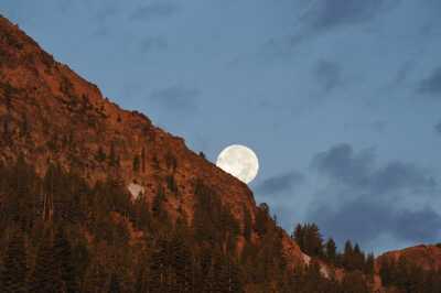 Full moon setting at sunrise