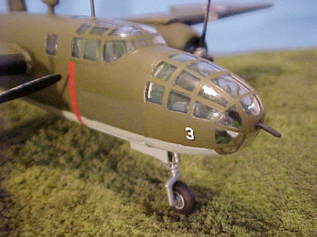 Close-up of the bombardier's compartment. It was glued on after I painted the fuselage, and unfortunately the clear plastic of the nosepiece took the paint a different way, hence the lighter shade of olive drab. The kit-supplied .50-caliber nose gun was cut down to more closely resemble the .30-caliber machine gun that was mounted in the nose.