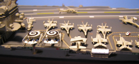 Some of the aircraft on the forward flight deck, including E2-C Hawkeyes radar planes, S3-B Viking sub hunters and F/A-18 Hornet fighter/bombers. The bright white box is the jettisonable storage locker for pyrotechnic devices.
