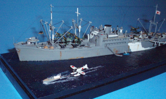 View of the bow area, showing a Jake getting towed to the beach after being off loaded. The wakes were made by drybrushing titanium white acrylic paint over the acrylic gel medium ocean surface.