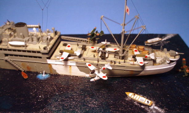 Lots going on here, with one Jake being hoisted out and another one getting readied. The white steam coming out of the ship's side simulates a waste discharge pipe. I made it out of stretched clear sprue with some white acrylic paint dabbed on it, and lightened the paint around the surface to try and simulate roiled up water.