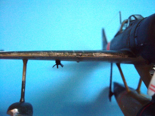 Two bits of super-detailing: A 20-mm cannon barrel peeks out of its wing mounting, built with a cut down piece of hypodermic syringe; and a scratchbuilt bomb rack under each wing, made with bits of plastic strip and square stock.