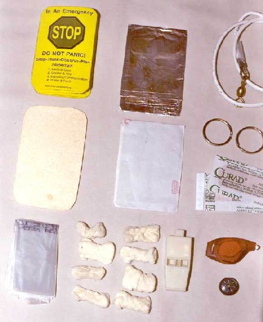 Close-up of signaling and fire starting contents.