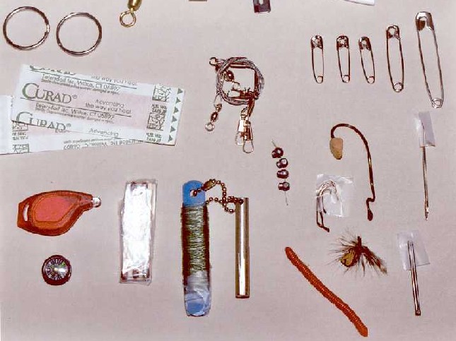 Close-up of fishing gear, flashlight and miscellaneous bits.