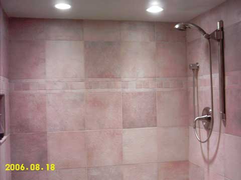 Lights in the shower highlight the tile work.