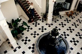 black and white tiles and a stone fountain