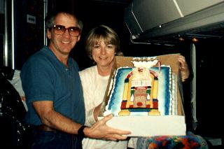 At the rear of the bus with the cake