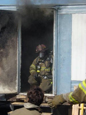 randyinfrontdoorwayofburningtrailerjuly2005-practi.jpg