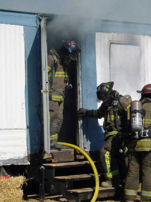 rtfdfirefighterswaitinggotointoburningtrailerjuly2.jpg