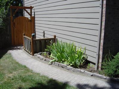 Front paver walkway and new gate, side of house